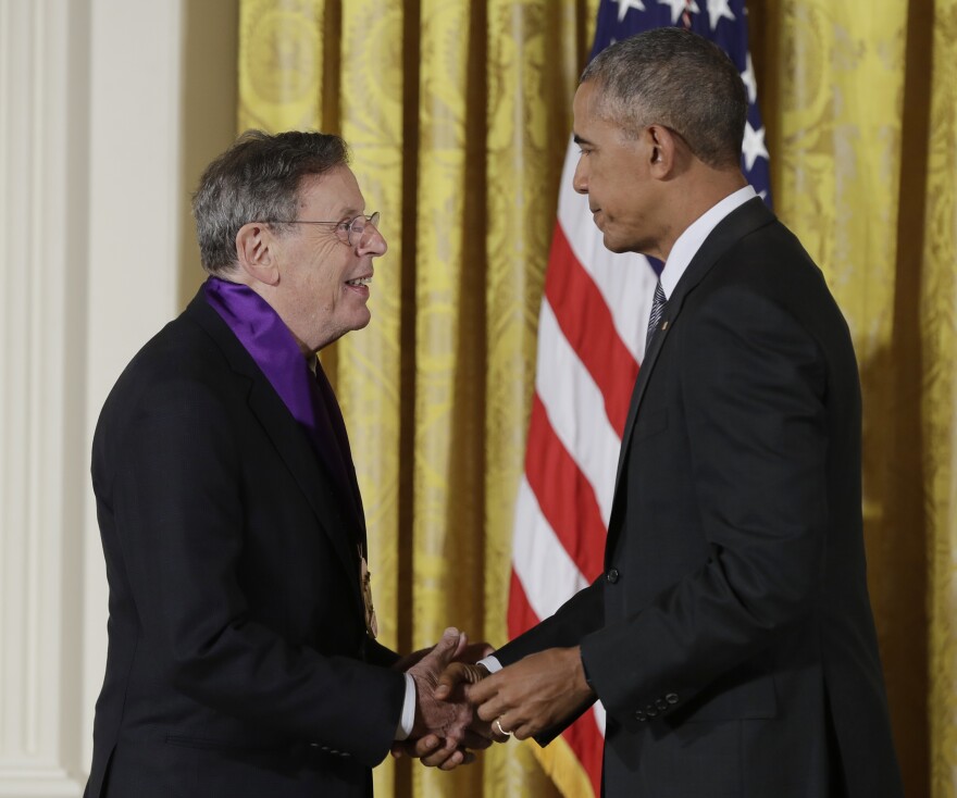 President Barack Obama awards the 2015 National Medal of Arts to composer Philip Glass during a ceremony in the East Room of the White House, Thursday, Sept. 22, 2016, in Washington. (AP Photo/Carolyn Kaster)