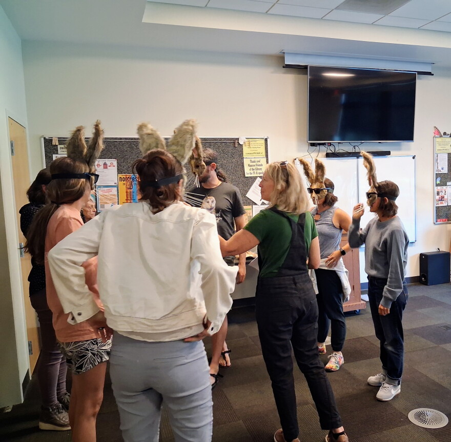 Performers try on rabbit masks during a Sept. 1 rehearsal for The Golden Fox Paradox at the Mancos Public Library. The production will lead audiences through downtown Mancos in October.