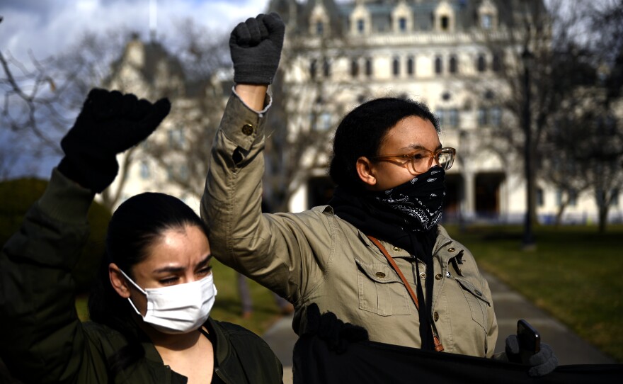 HARTFORD, CT - January 20, 2021: Suomia Dode 23 of Plainville, (left) and organizer Alicia Strong 24, of New Britain, part of a small group of state wide activists bringing attention to their cause on the grounds of the Sate Capitol in Hartford on January 20, 2021. (Joe Amon/Connecticut Public)