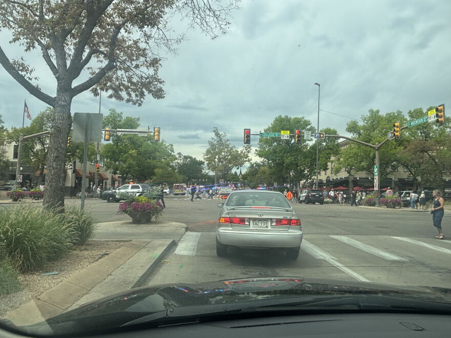 Police cars line a busy downtown street