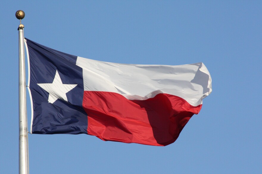The Texas flag flies in Austin.