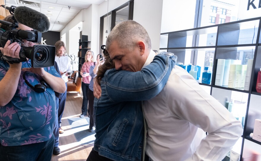 Rep. Brooke Green (D-Boise), center, hugs Rep. John Shirts (R-Weiser) after he shaved his head. Green has been undergoing treatment for breast cancer and will soon shave her head.