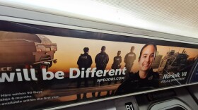 A recruitment poster for the Norfolk, Virginia Police Department hangs inside a New York City subway train in July 2022. Photo by Dan Morisson // VCIJ at WHRO