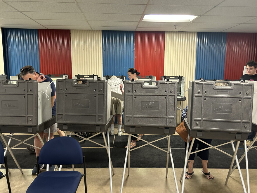 Voters cast their ballots at booths on Primary Election Day, Aug. 11, 2026, at the Chisholm Athletic Complex.