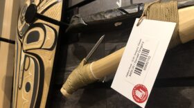 Artwork for sale at the Sealaska Heritage Institute shop on Friday, June 16, 2023, bears a label declaring it compliant with the Indian Arts and Crafts Act. The federal government has filed several recent cases in Alaska for violations of the act. (Photo by James Brooks/Alaska Beacon)