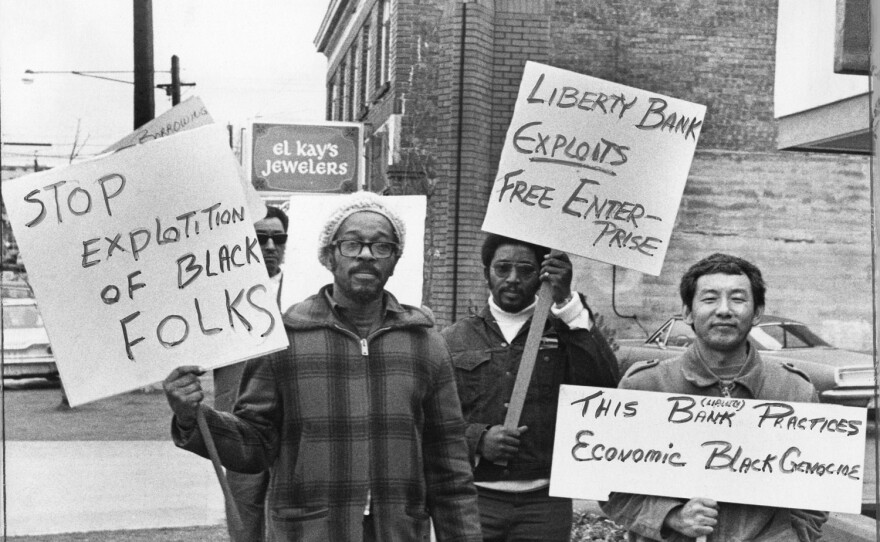 Picketers protest in front of Liberty Bank in 1972 for 'selective lending' practices.