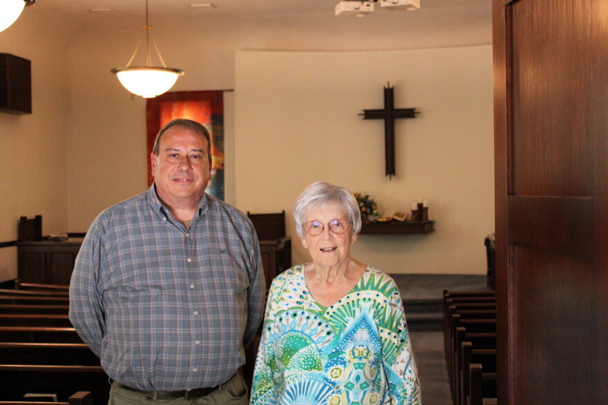 A man and older woman stand next to each other in North Danvers Mennonite Church