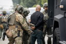 Immigration and Customs Enforcement (ICE) officers detain a man during an operation in Los Angeles, California on June 12, 2025.
