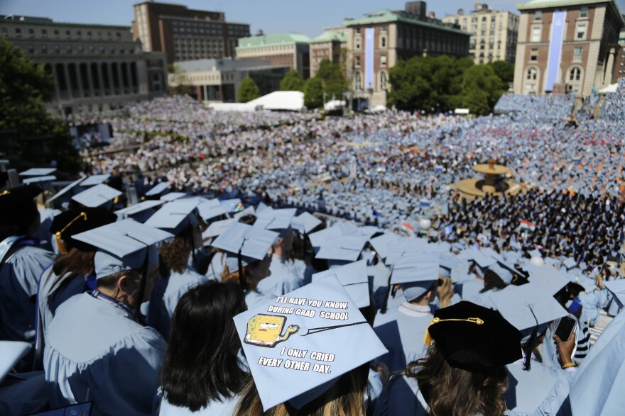 Graduating students fill the Columbia University campus in New York City during a 2017 graduation ceremony. Nearly 45 million Americans owe $1.6 trillion in college loan debt, and the federal government is considering a variety of approaches to either forgiving that debt or relieving the burden of monthly repayments. (AP Photo/Seth Wenig, File)