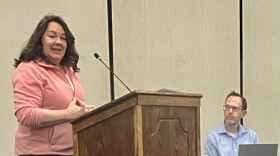 Robin Leasure, who said she lives 380 feet away from a proposed adult-use cannabis dispensary in Washington, speaks out against the facility Monday at a City Council meeting. Listening is Jon Oliphant, the city's planning and development director.