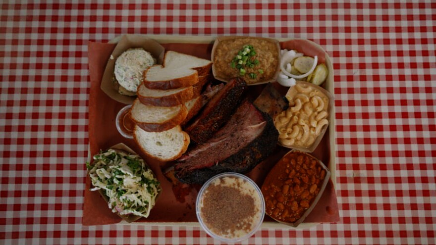 A tray at Goldee’s Barbecue features smoked brisket, ribs, sausage, turkey, house-made bread and a selection of sides.