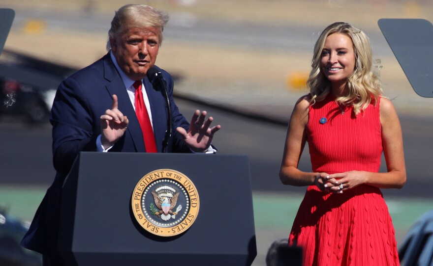 President Trump introduces White House press secretary Kayleigh McEnany at the rally in Prescott, Ariz. Like the president, McEnany has recovered from the coronavirus.