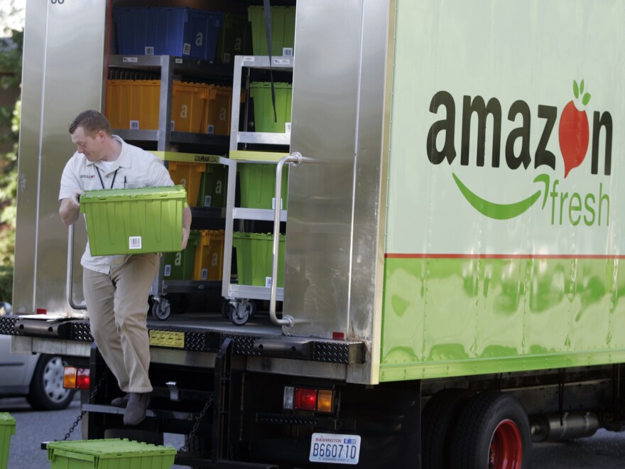 Amazon Fresh delivery man Tim Wilkie totes food to a house on Mercer Island, Wash.