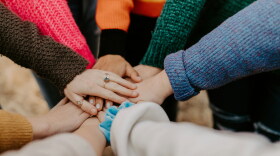 A group of hands stacked on top of each other.