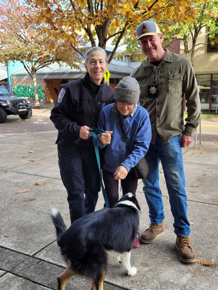 A woman is reunited with her dog Beau by EPD staff.