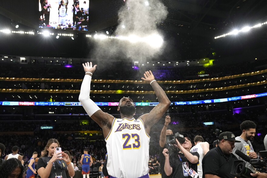 Los Angeles Lakers forward LeBron James tosses powder in the air prior to an NBA basketball game against the Denver Nuggets Saturday, March 2, 2024, in Los Angeles. 