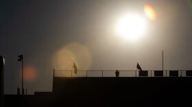 An intense sun beats upon Eastwood High School's stadium as a security guard stands on duty, Aug. 28, 2026.
