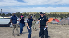  Oregon Gov. Kate Brown greets Incident Commander Ian Yocum and other fire officials at a camp
located in Bly for firefighters fighting the Bootleg Fire in Klamath and Lake Counties.