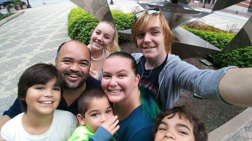 A selfie with the Urriola family in the foreground. Misty's two older children — Erica Donaldson and Ryan Buller — are in the back row.
