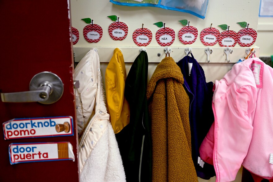 Students' jackets belonging to four and five-year-olds hang on hooks by the classroom door at Hope for New Haven Day Care Center on April 26, 2022.