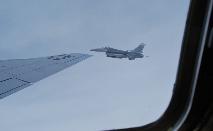 One of the Wisconsin Air National Guard's F-16s flies next to the KC-135.