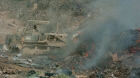A soldier manages a burn pit in Balad, Iraq. The pits were widely used in the early 2000s and have now been linked to a number of medical issues, including cancer and chronic lung disease. (Photo courtesy of the Department of Defense.)