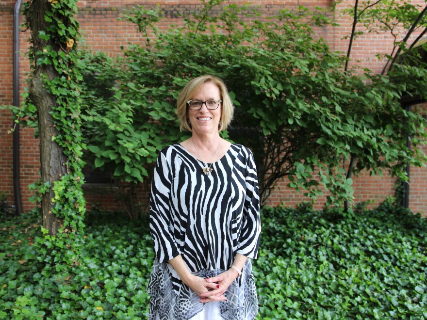 Photo of Cynthia Bell outside in front of brick wall