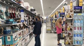 FILE - Consumers shop at a Walmart store in Vernon Hills, Ill., Sunday, May 23, 2021. U.S. consumer confidence fell in August to the lowest level since February amid rising concerns about the rapidly spreading delta variant of the coronavirus and worries about higher inflation. The Conference Board reported Tuesday, Aug. 31, 2021 that its consumer confidence index dropped to a reading of 113.8 in August, down from a revised 125.1 in July. (AP Photo/Nam Y. Huh, file)
