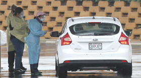 Nurses greet a patient in their car to be tested for COVID-19 at the Mercy Virtual Care Center in Chesterfield earlier this month. Health care workers are sounding the alarm they don't have enough personal protective equipment to wear.