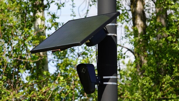 A Flock camera is mounted on a poll to help catch speeders.