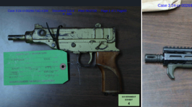 Guns seized as evidence sitting on a table in the Demorion "Duck" Baker case.