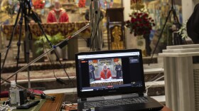 Catholic priests live video stream the Palm Sunday mass inside the Jesus de Medinaceli church in Madrid, Spain, Sunday, April 5, 2020. 