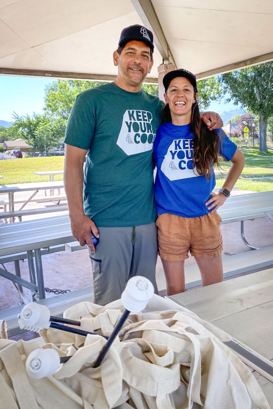 Volunteers Chris Knoles and Roxanne Christiansen pose at Poplar Grove Park, July 15, 2023, with the monitors used to collect data in the foreground.