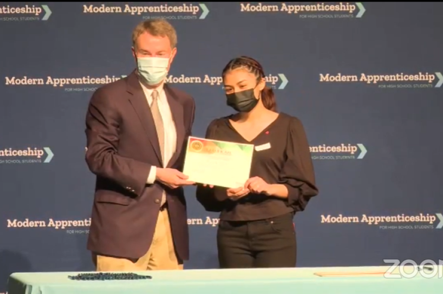 Indianapolis Mayor Joe Hogsett poses for a photo with Ben Davis High School student Ruby Galvan. Galvan will be an apprentice with the city government.
