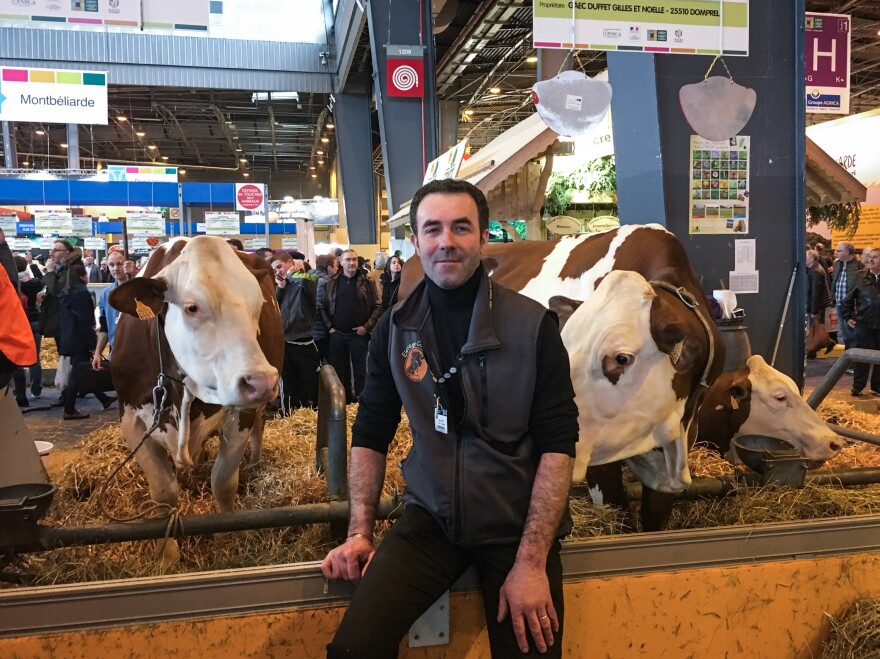 Thierry Chabot's Montbeliard cows wear giant bells around their necks. Chabot makes Comté cheese in the mountains near the Swiss border. He doesn't like presidential front-runner Marine Le Pen's ideas about leaving the European Union.