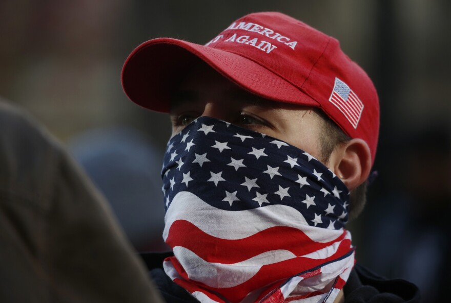 An attendee wears an American flag mask during the United Against Hate rally by the Washington Three Percent in Seattle last month.