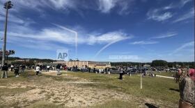 Students are evacuated to the football stadium after the school campus was placed on lockdown at Apalachee High School in Winder, Ga., on Wednesday, Sept. 4, 2024. (Erin Clark via AP)
