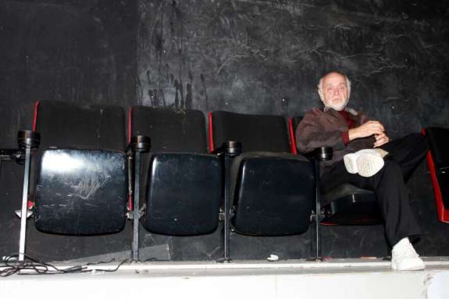 Owner Frank Hilgenberg sits on one of the few remaining seats as workers empty out the theatre. Photo: Nicole Creston