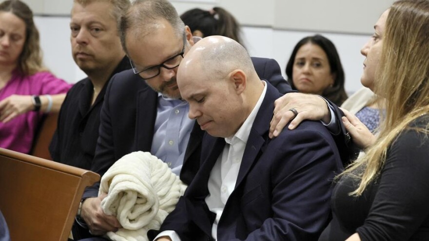 Ryan Petty comforts Ilan Alhadeff as they await the verdict in the trial of Parkland shooter Nikolas Cruz at the Broward County Courthouse in Fort Lauderdale on Thursday, Oct. 13, 2022. Petty's daughter, Alaina, and Alhadeff's daughter, Alyssa, were killed in the 2018 shootings. 