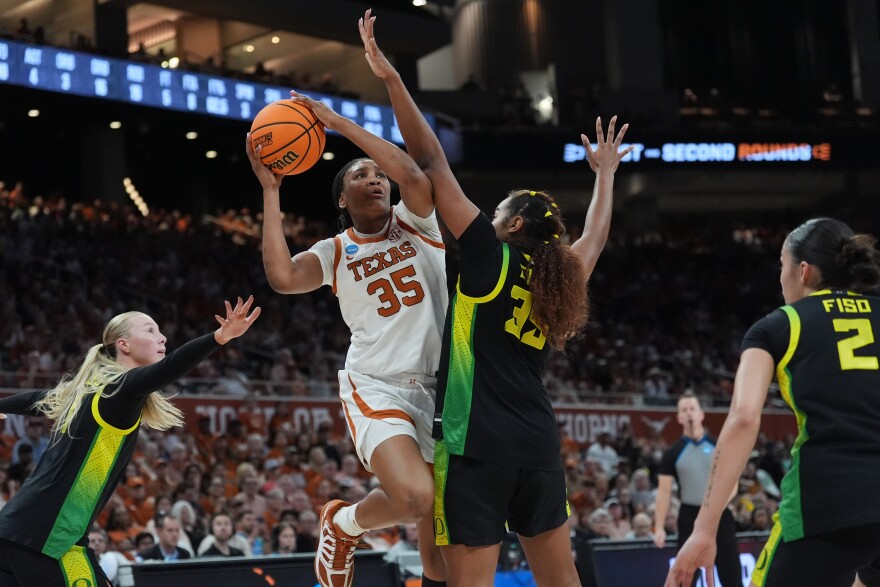 Texas forward Madison Booker drives to the basket against Oregon forward Ehis Etute.