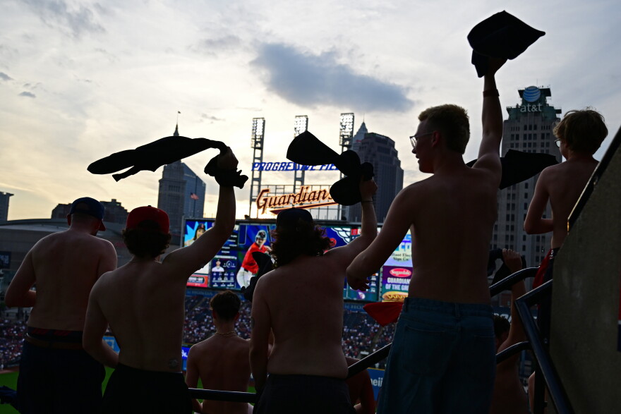 Fans participate in "tarps off", waving their shirts during the fifth inning of a baseball game between the Cleveland Guardians and New York Yankees, Tuesday, June 9, 2026, in Cleveland. 