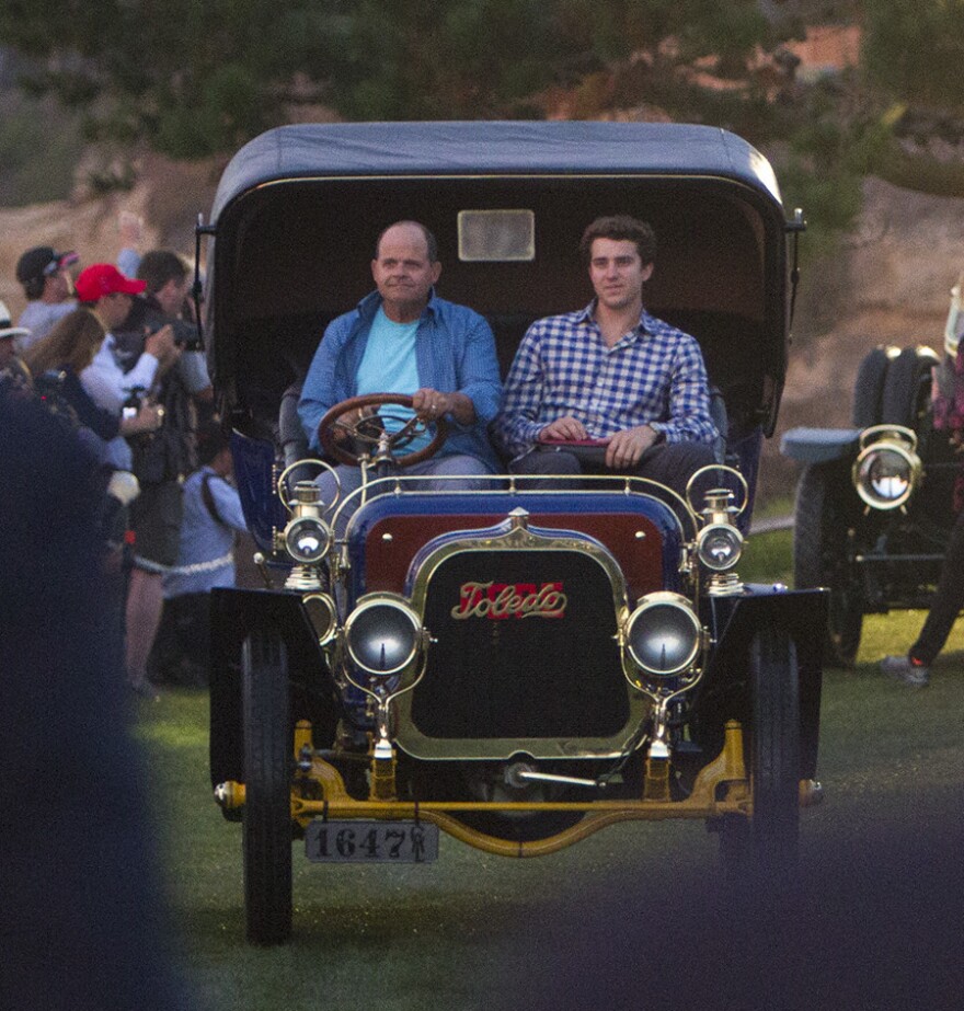 Bill Evans and his son Billy, of San Diego drives his 1905 Pope Toledo Type IV Roi des Belges Tonneau pre dawn, Sunday morning onto the 18th green at The Lodge at Pebble Beach in 2015