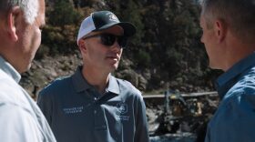 Utah Gov. Spencer Cox, center, tours wildfire and flood stricken areas in Beaver County on Aug. 6, 2026.