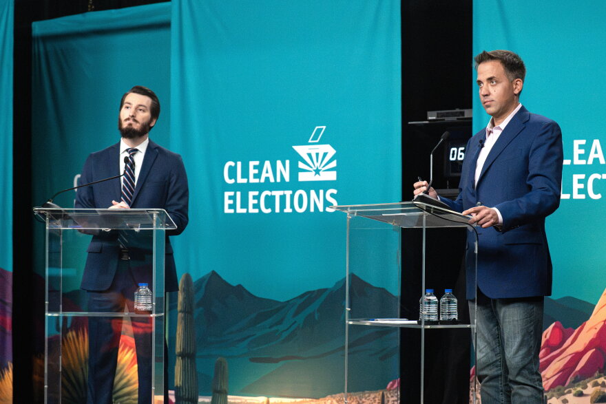Greg Blackie, left, a supporter of Proposition 144, debates referendum foe Randy Keating Thursday night.