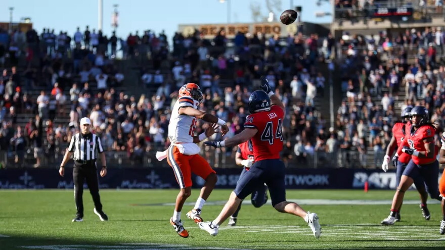 Syracuse quarterback Amari Odom (12, White) heaves a pass towards the end zone during SU’s 42-41 overtime win over UConn Saturday.