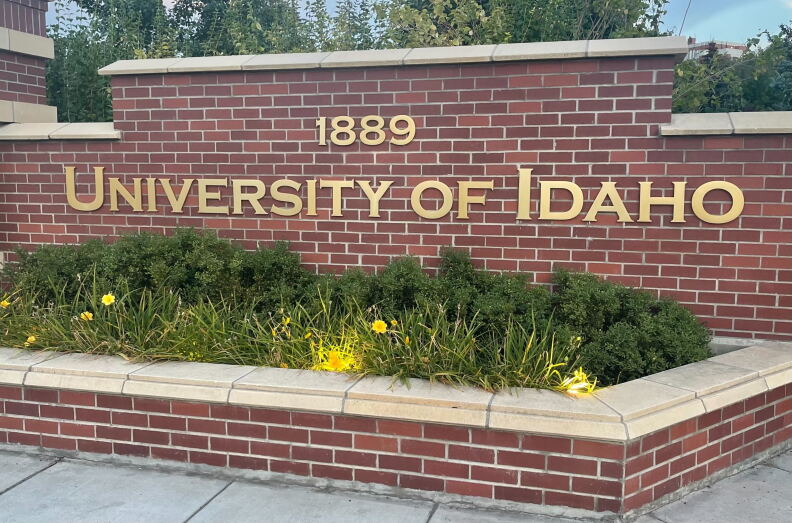 A brick wall with University of Idaho in gold letters written on it with the date 1889 above it.