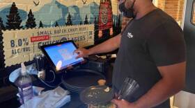 Server Lacey Crosby said he's happy to be working, despite the challenges.
