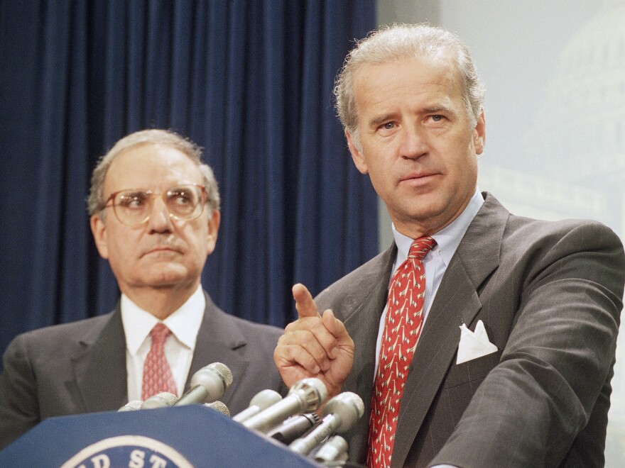 Then-Sen. Joe Biden (right) speaks at a Capitol Hill news conference in 1994 after the Senate voted on a major crime bill. [John Duricka / AP]