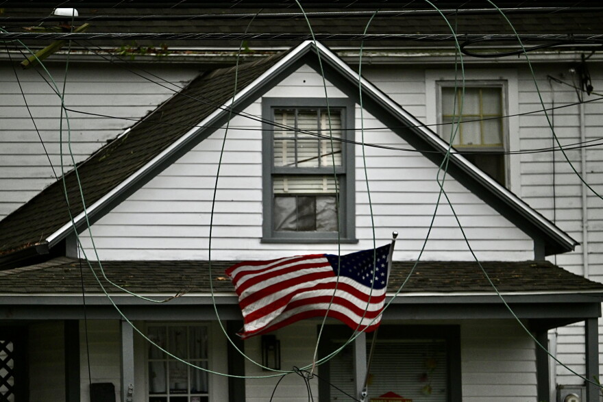 A flag surrounded by broken power lines waves in a nor’easter’s wind moving through Mansfield, Ct., September 27, 2026