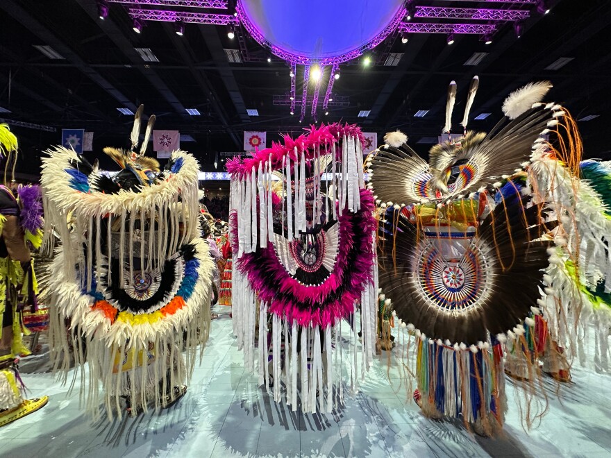Dancers pause under the arena lights during the grand entry at the last Gathering of Nations powwow in Albuquerque, New Mexico, on Friday, April 24, 2026.
